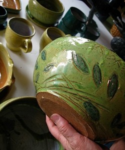 Virgina Wyoming holding flower pot with leaf motif in studio